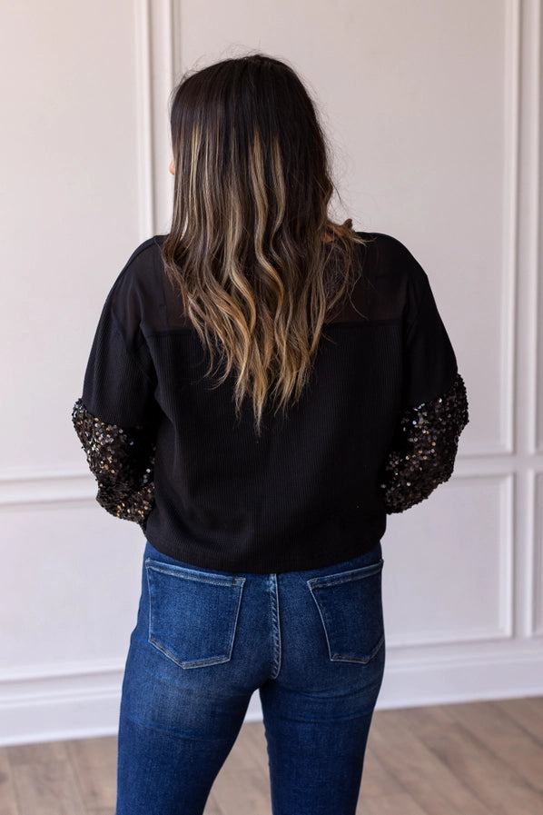 BLACK WAFFLE WITH SEQUIN SLEEVE