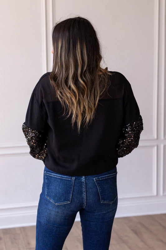 BLACK WAFFLE WITH SEQUIN SLEEVE